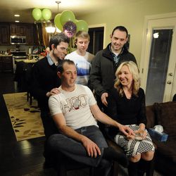 Nanette Wride, wife of fallen Utah County Sgt. Cory Wride, sits with her sons Shea Wride (top left), Tyesun Wride (top center), Nathan Mohler (top right) and Chance Wride (left) to share some of their fond memories and the type of person Cory was at their home on Sunday, February 2, 2014.
