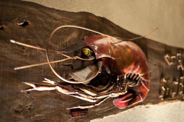 A large shrimp wall-hanging sculpture. 