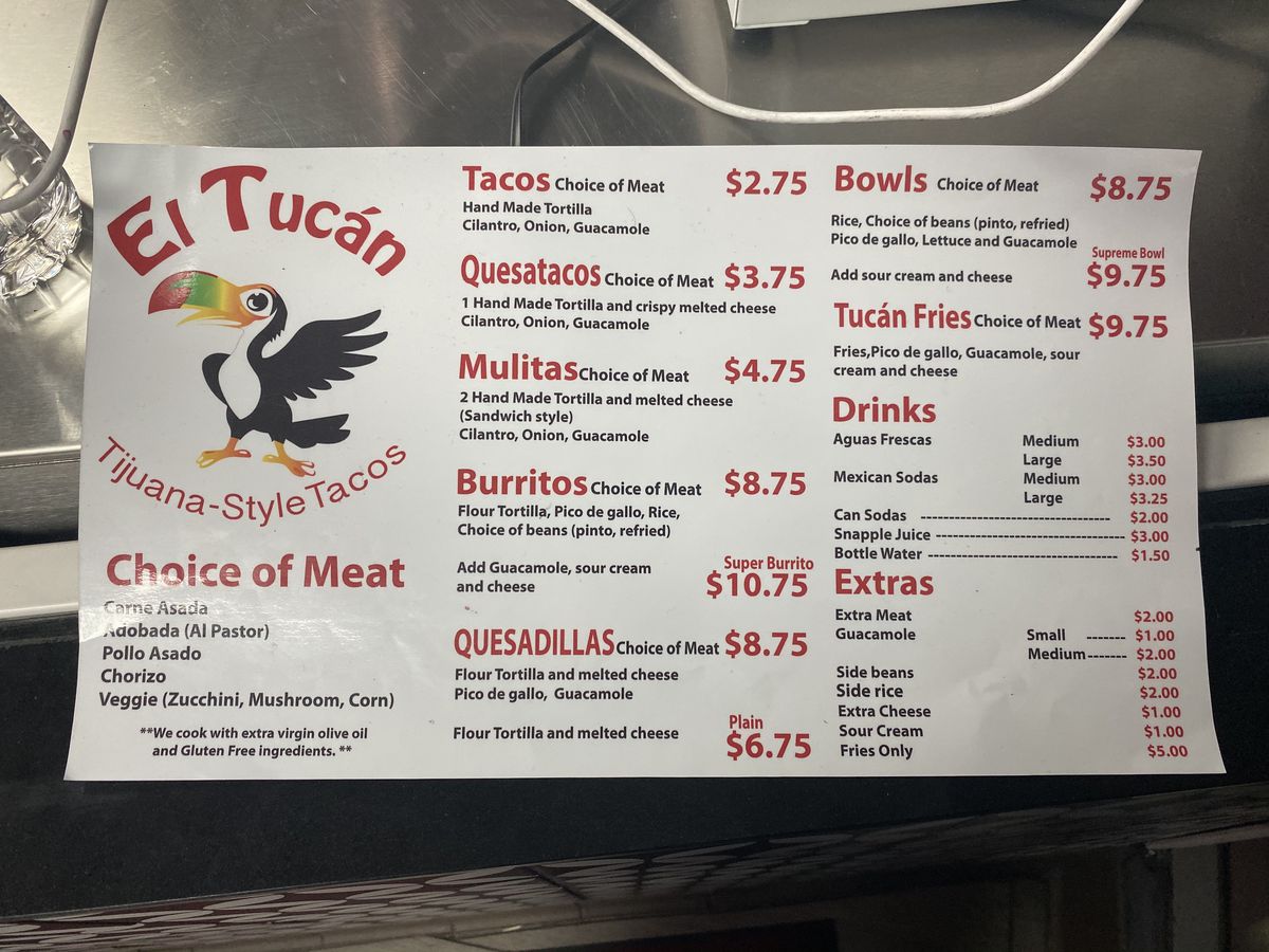 The menu board at Tacos El Tucán