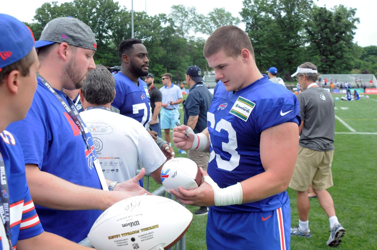 PITTSFORD, NY - Buffalo Bills rookie defensive tackle Justin Zimmer (63) signs autographs for fans after the first training camp session at St. John Fisher College.