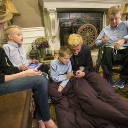 Nathan Honey and his sister Jessica, talk with their brothers Anthony, Andrew, and Joshua Sunday, Nov. 16, 2014, after church in American Fork. Four of the Honey boys struggle with muscular dystrophy. 