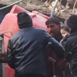 In this image made from Tuesday, Jan. 7, 2014, amateur video released by Ugarit News, which has been authenticated based on its contents and other AP reporting, people carry a girl out of rubble in Douma, Syria. In the town close to the Syrian capital of Damascus, several people were killed and wounded after a government airstrike targeted a house on Tuesday, reported the Observatory and another activist group, the Local Coordination Committees.