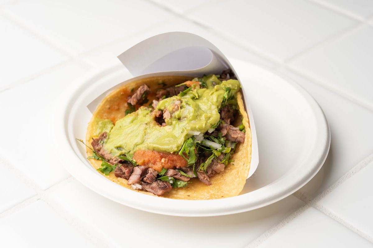 Carne asada taco from Tacos 1986 on a paper plate.