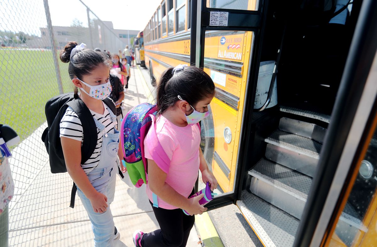 Students at Woodrow Wilson Elementary School in South Salt Lake wear masks as the get on a bus to go home after their first day of school on Monday, Aug. 24, 2020.