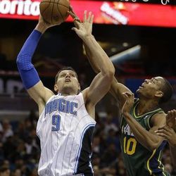 Orlando Magic's Nikola Vucevic (9), of Montenegro, goes up to shoot over Utah Jazz's Alec Burks (10) during the first half of an NBA basketball game in Orlando, Fla., Wednesday, Dec. 18, 2013. (AP Photo/John Raoux)