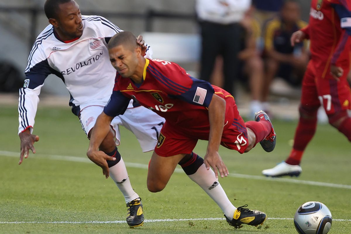 SANDY UT - JULY 2: Alvaro Saborio #15 of Real Salt Lake is tripped up by Sainey Nyassi #17 of the New England Revolution during the first half of an MLS soccer game at Rio Tinto Stadium July 2 2010 in Sandy Utah. (Photo by George Frey/Getty Images)