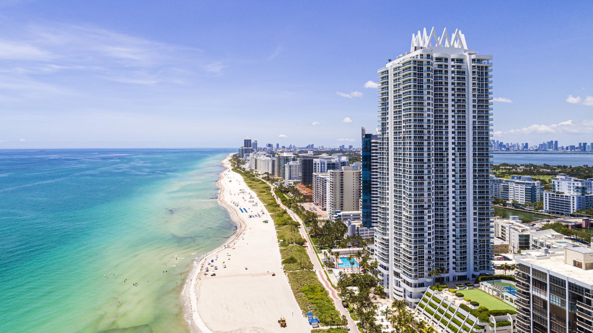 Miami Beach, Florida, aerial view, shoreline public beach, Boardwalk bike path trail, Akoya high rise building
