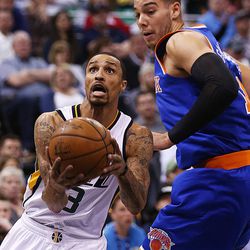 Utah Jazz guard George Hill (3) ducks under and around New York Knicks center Willy Hernangomez (14) for a layup as the Utah Jazz and the New York Knicks play at Vivint Arena in Salt Lake City on Wednesday, March 22, 2017. The Jazz beat the Knicks 108-101.