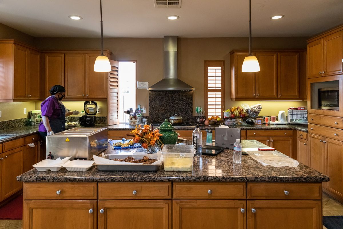 Evon McMurray’s home kitchen in Eastvale, California with hanging lights.