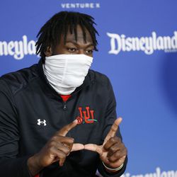 Utah Utes linebacker Devin Lloyd flashes a “U” during a press conference at Disneyland in Anaheim, Calif., on Monday, Dec. 27, 2021, as part of events leading up to the Rose Bowl.
