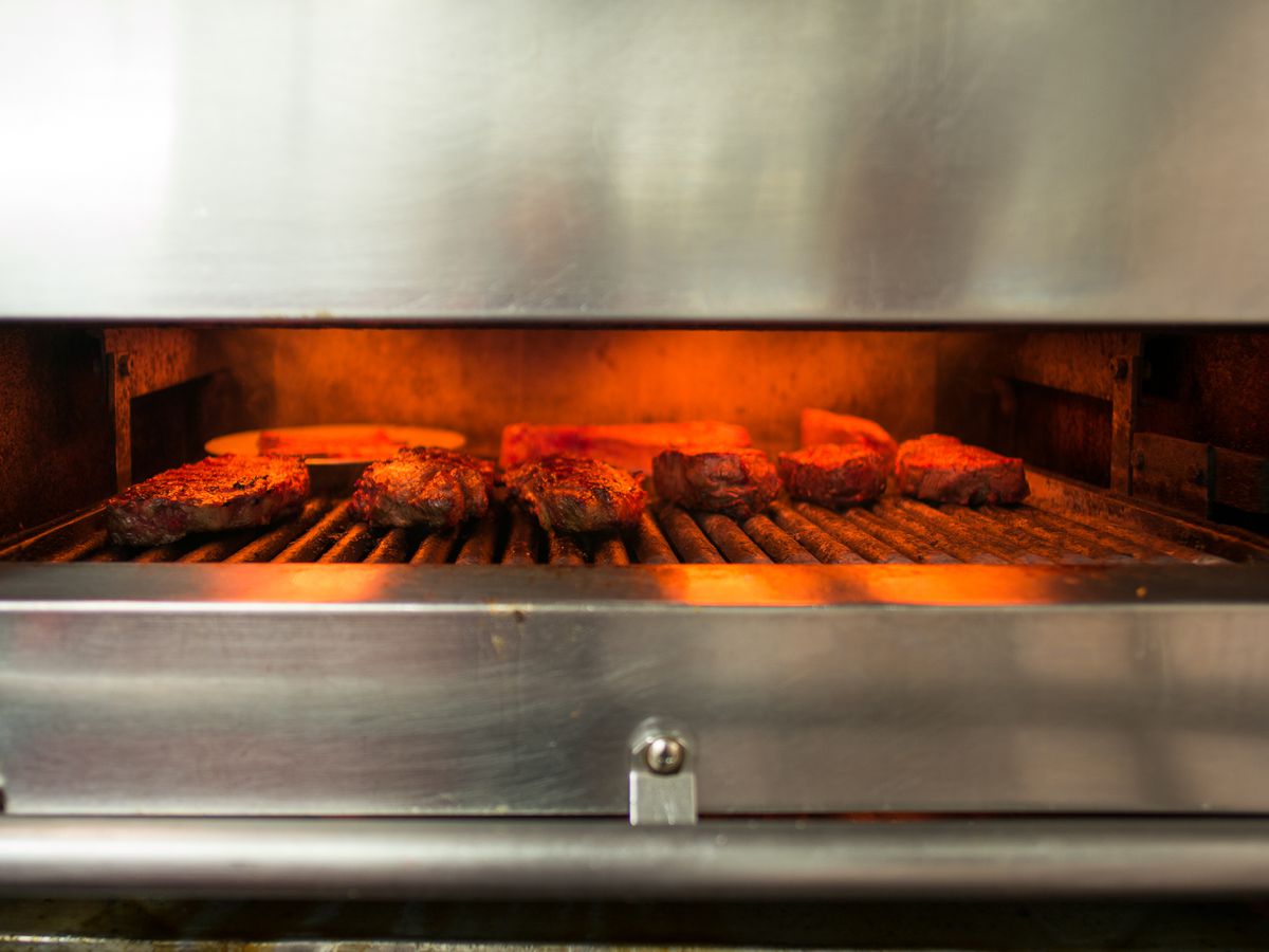 Steaks under a broiler