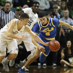 Oregon's Payton Pritchard, with teammate Chris Boucher, center, forces a turnover against UCLA's Lonzo Ball during the first half of an NCAA college basketball game Wednesday Dec. 28, 2016, in Eugene, Ore. 