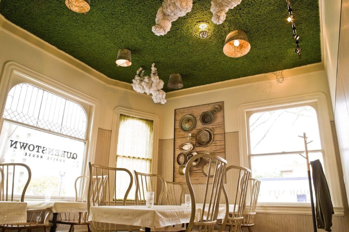 A charming dining room with sheep on the ceiling.