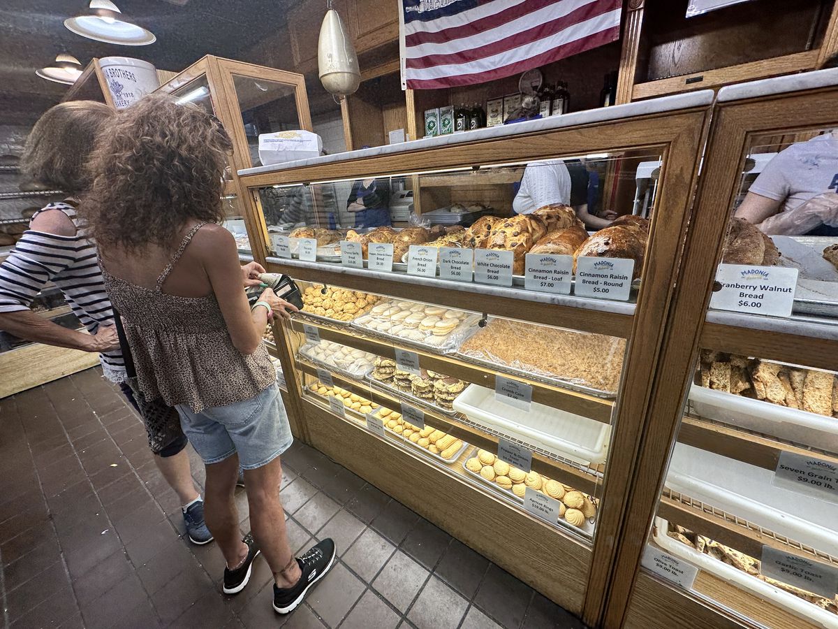 A customer looks at a pastry case.
