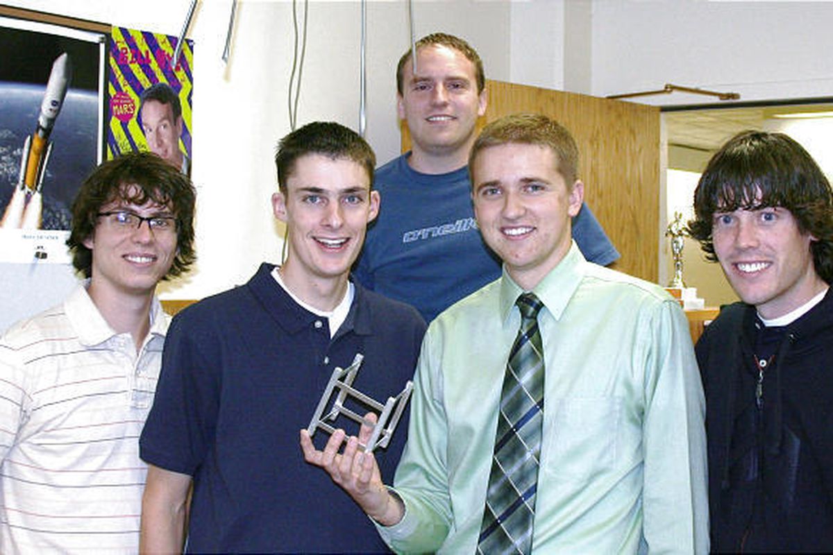 USU students, from left, Phillip Anderson, Steve Berkley, Jeff Brady, Ryan Schaefermeyer and Jacob Beck display a prototype frame for a tiny CubeSat satellite.
