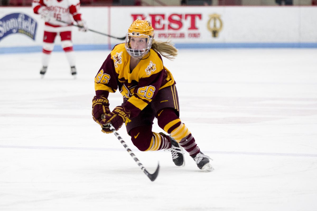 Sarah Potomak of the Minnesota Golden Gophers skates up the ice with the puck.