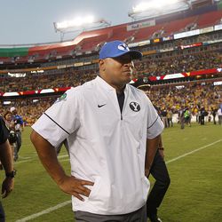 Brigham Young Cougars head coach Kalani Sitake and players leave the field after the Cougars fell to West Virginia 35-32 at FedEx Field in Landover, Maryland on Saturday, Sept. 24, 2016.