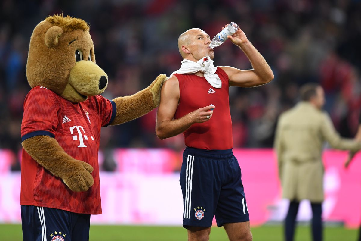 The Bayern Munich's mascot reacts with Bayern Munich's Dutch midfielder Arjen Robben after the German first division Bundesliga match between FC Bayern Munich and FC Augsburg in the stadium in Munich, southern Germany, on September 25, 2018.