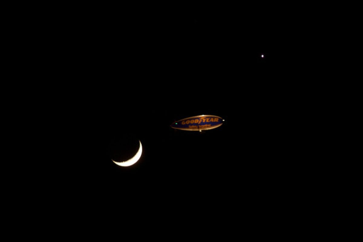 That is the moon, a Goodyear Blimp and Venus.  All in one shot by @nathanrae