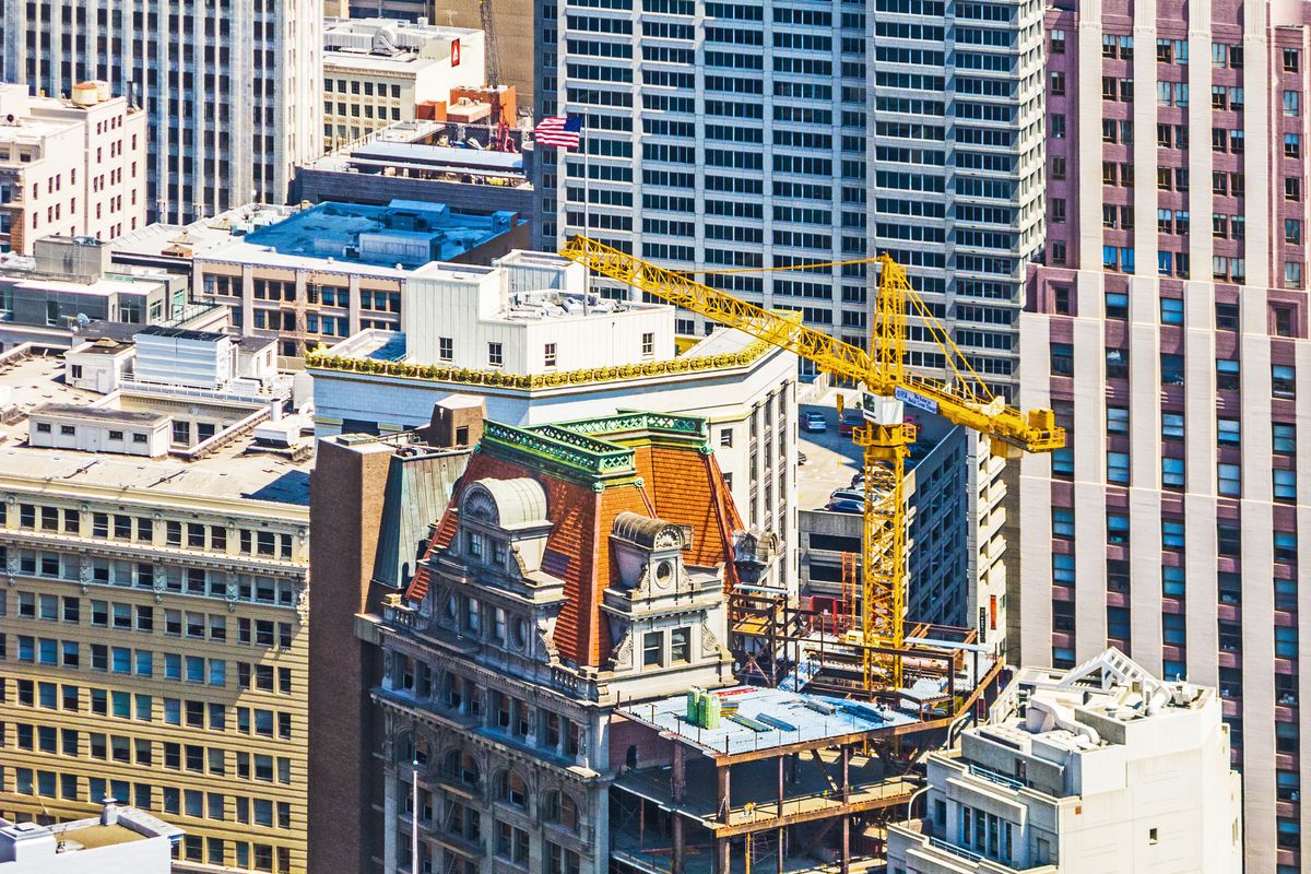 Construction cranes on top of a San Francisco building.