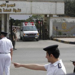 Egyptian policemen stop traffic to secure an ambulance carrying former Egyptian president Hosni Mubarak as it leaves Maadi Military Hospital to cross the street where an air ambulance will take him to attend his retrial hearing in Cairo, Egypt, Saturday, April 13, 2013. Egypt's highest court in January ordered a retrial for Mubarak, for failing to stop the killing of 900 protestors in the 2011 unrest that ousted him, after accepting an appeal against his life sentence, citing procedural failings. 