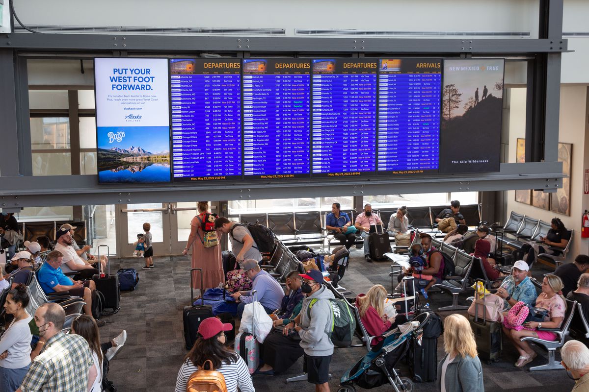 Travelers wait to board their flight at a Southwest gate in an Austin, Texas, airport. 