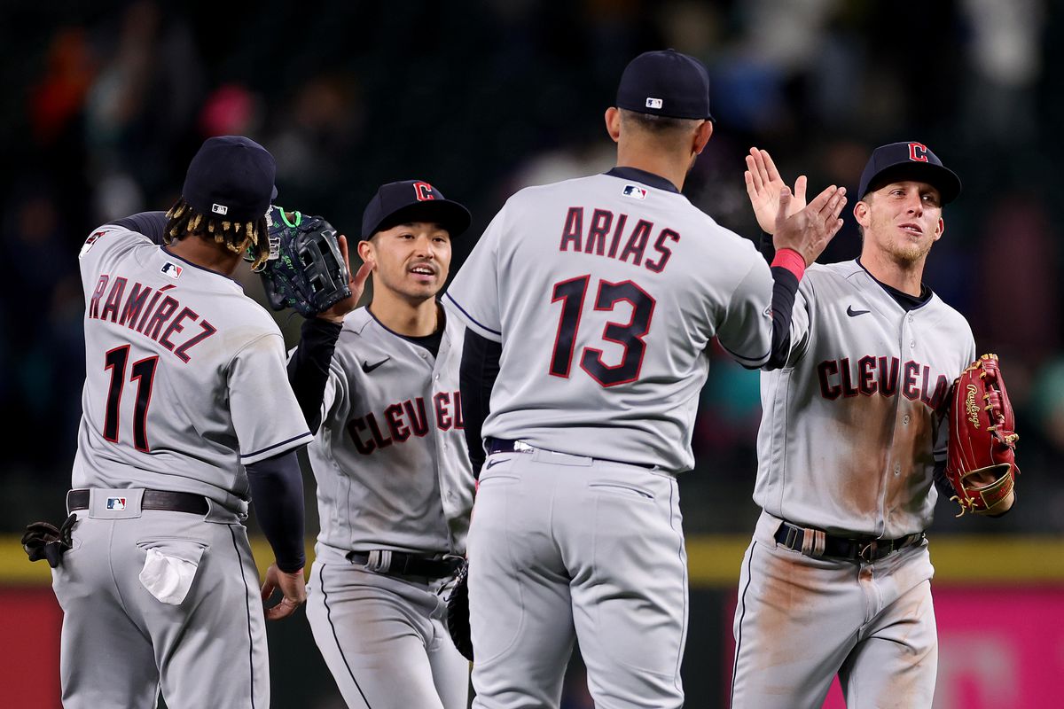Jose Ramirez #11, Steven Kwan #38, Gabriel Arias #13 and Myles Straw #7 of the Cleveland Guardians celebrate their 9-4 win against the Seattle Mariners at T-Mobile Park on March 31, 2023 in Seattle, Washington.