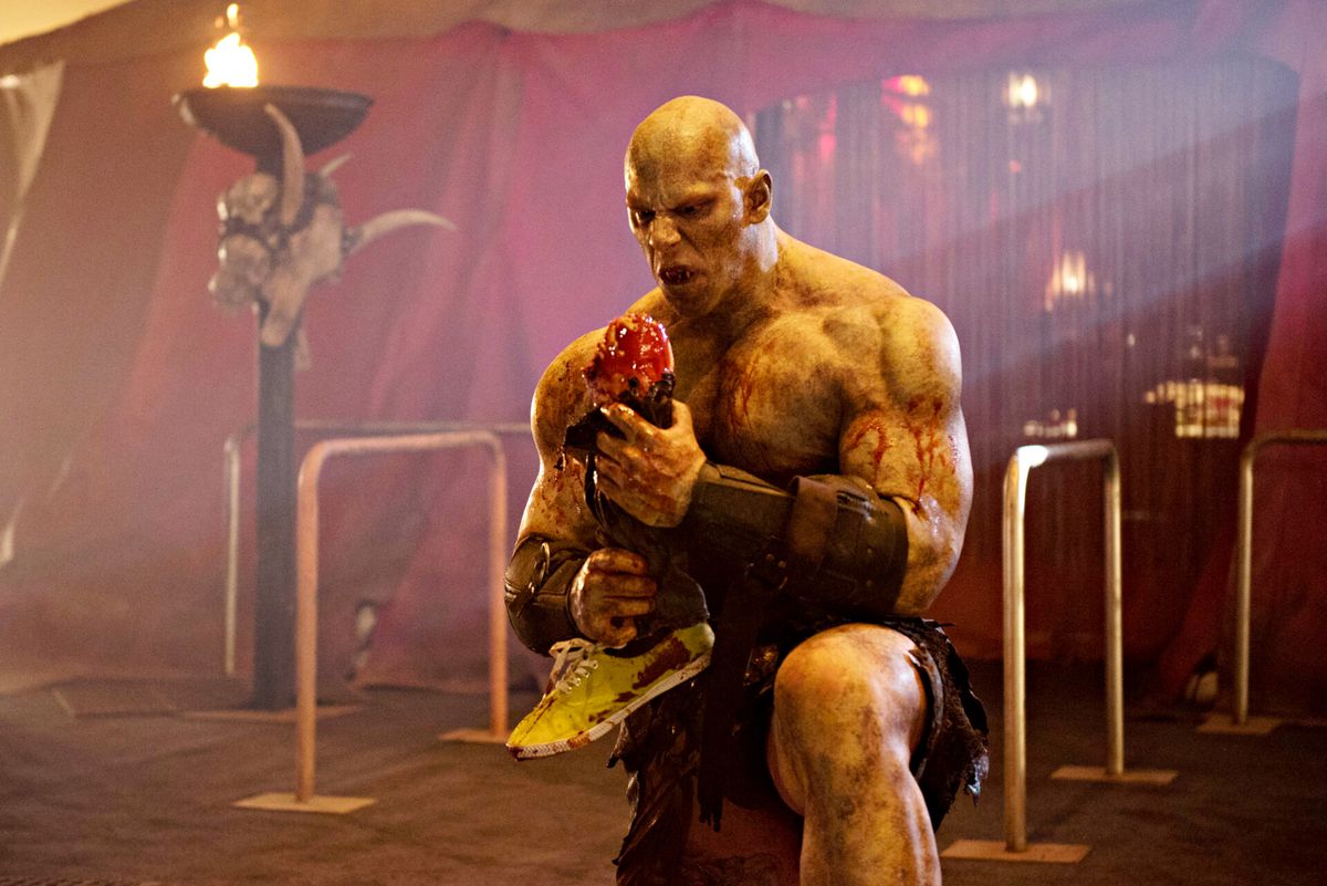 Martyn Ford as The Ogre, eating a severed leg, in the Syfy series Blood Drive