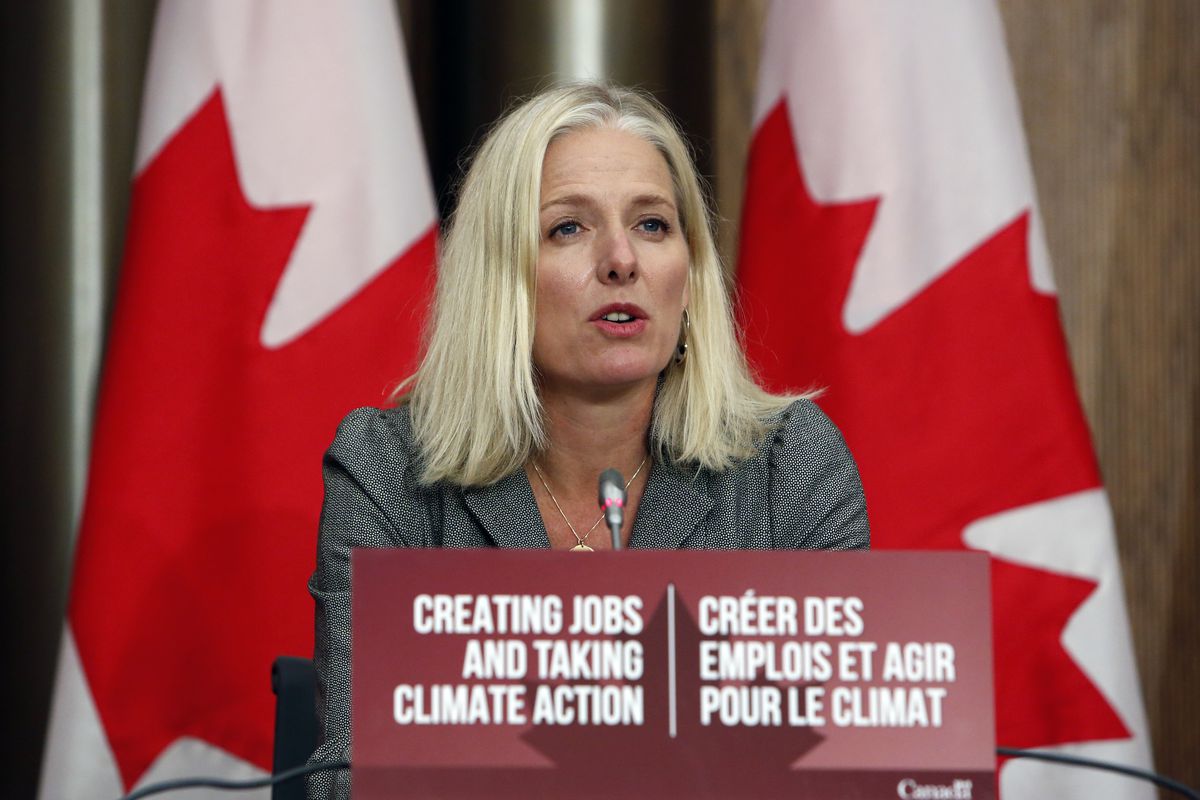 Catherine McKenna, Canada’s infrastructure and communities minister, speaks during a news conference in Ottawa, Ontario, Canada, on Thursday, October 1, 2020. She is speaking in front of a sign that reads “Creating jobs and taking climate action” in English and in French. Two red-and-white Canadian flags stand behind her.