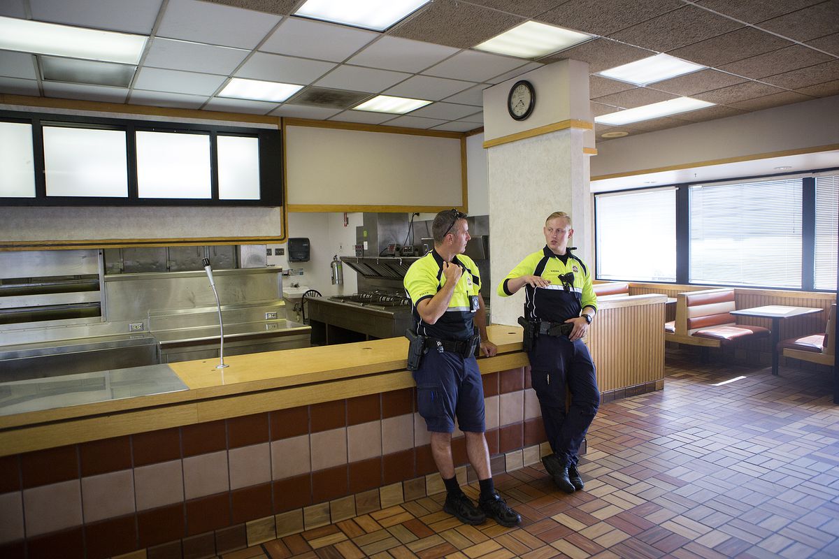 Officer Jared Tadehara, right, talks to officer Sean Werner while they lean on the counter at a new police bike patrol substation that used to be an Arctic Circle restaurant on North Temple in Salt Lake City on Wednesday, July 25, 2018.
