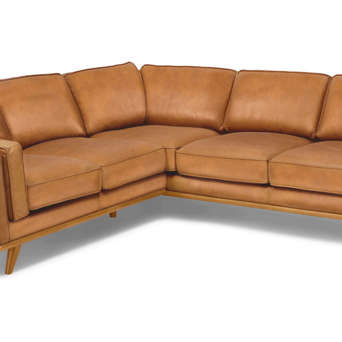 A light brown leather sectional sofa with five seats and plush cushions.
