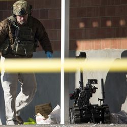 An FBI agent walks away from a detonated package after inspecting it outside the mail operations center of The Church of Jesus Christ of Latter-day Saints, 48 S. 400 East, in Salt Lake City on Thursday, Dec. 29, 2016. The package was considered suspicious after the bomb squad X-rayed it and discovered electronic items inside.