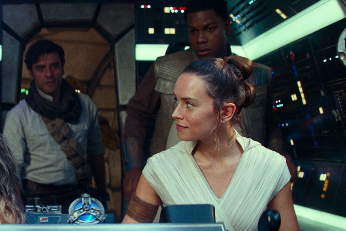 Star Wars: The Rise of Skywalker characters Chewbacca, Poe, Rey, and Finn look at each other in the Millennium Falcon.