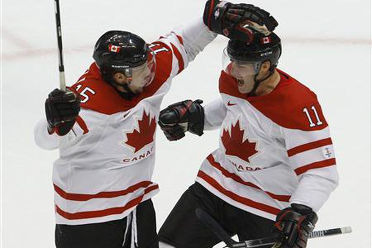 Patrick Marleau (11) of Canada celebrates his goal against Slovakia with Dany Heatley (15) in their mens's play-offs semifinals hockey game at the Vancouver 2010 Winter Olympics February 26, 2010.

REUTERS/Todd Korol