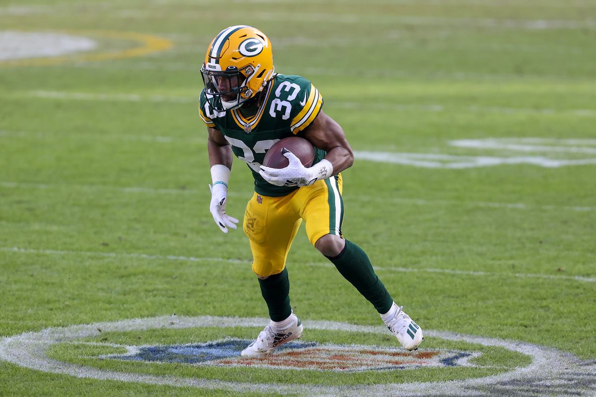 Aaron Jones #33 of the Green Bay Packers runs with the ball in the second quarter against the Tampa Bay Buccaneers during the NFC Championship game at Lambeau Field on January 24, 2021 in Green Bay, Wisconsin.