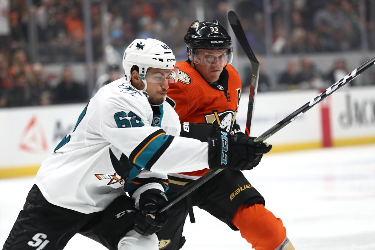 ANAHEIM, CALIFORNIA - OCTOBER 05: Kevin Labanc #62 of the San Jose Sharks battles Jakob Silfverberg #33 of the Anaheim Ducks for position during the first period of a game at Honda Center on October 05, 2019 in Anaheim, California.  