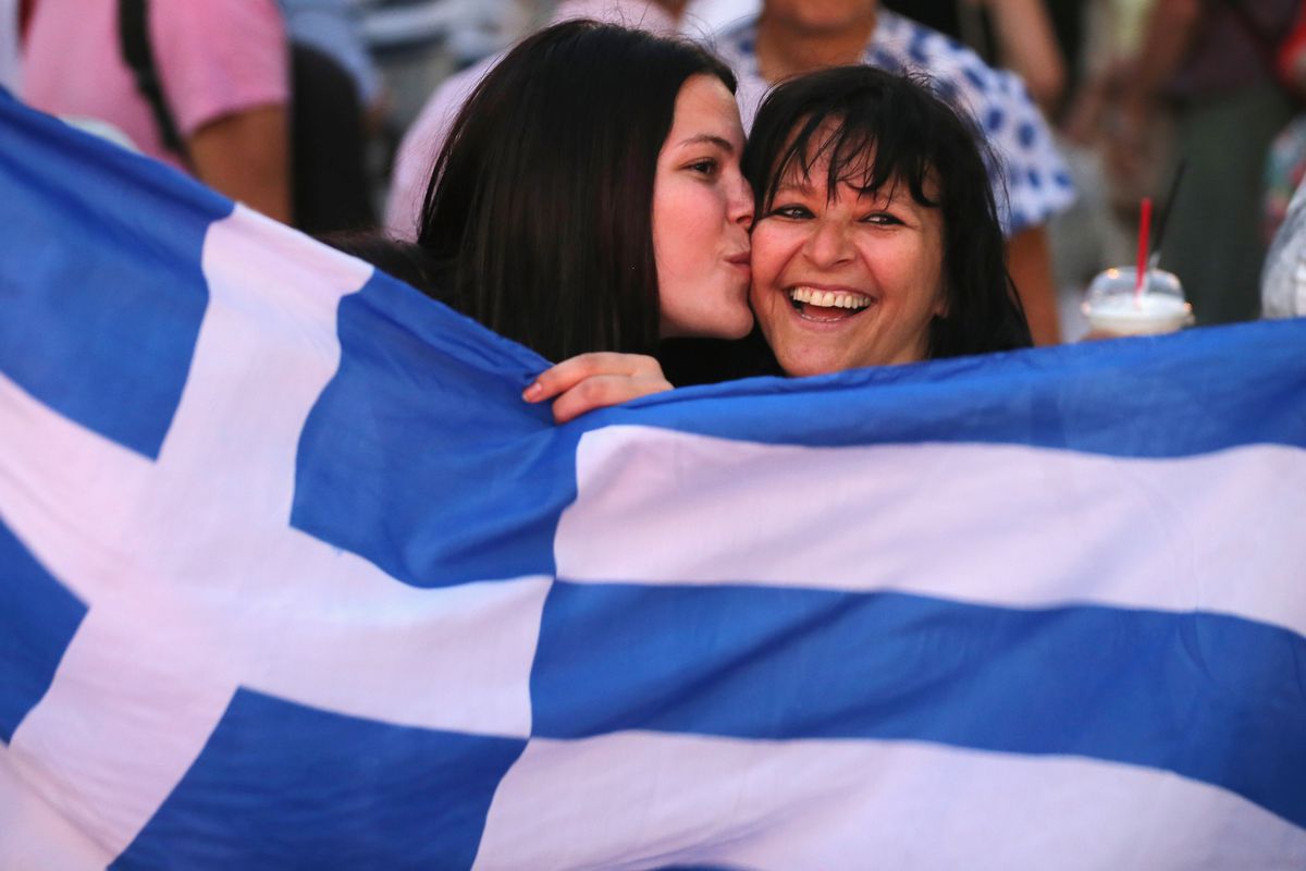 Greek supporters of a "no" vote celebrate their projected victory.