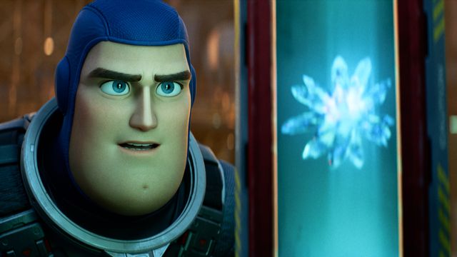 Buzz Lightyear looks at a shiny floating crystal in the Pixar movie Lightyear