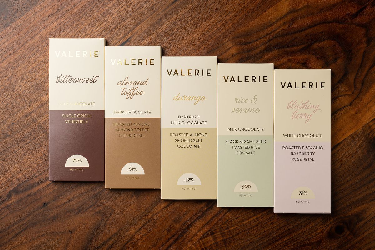 A row of five Valérie Confections chocolate bars.