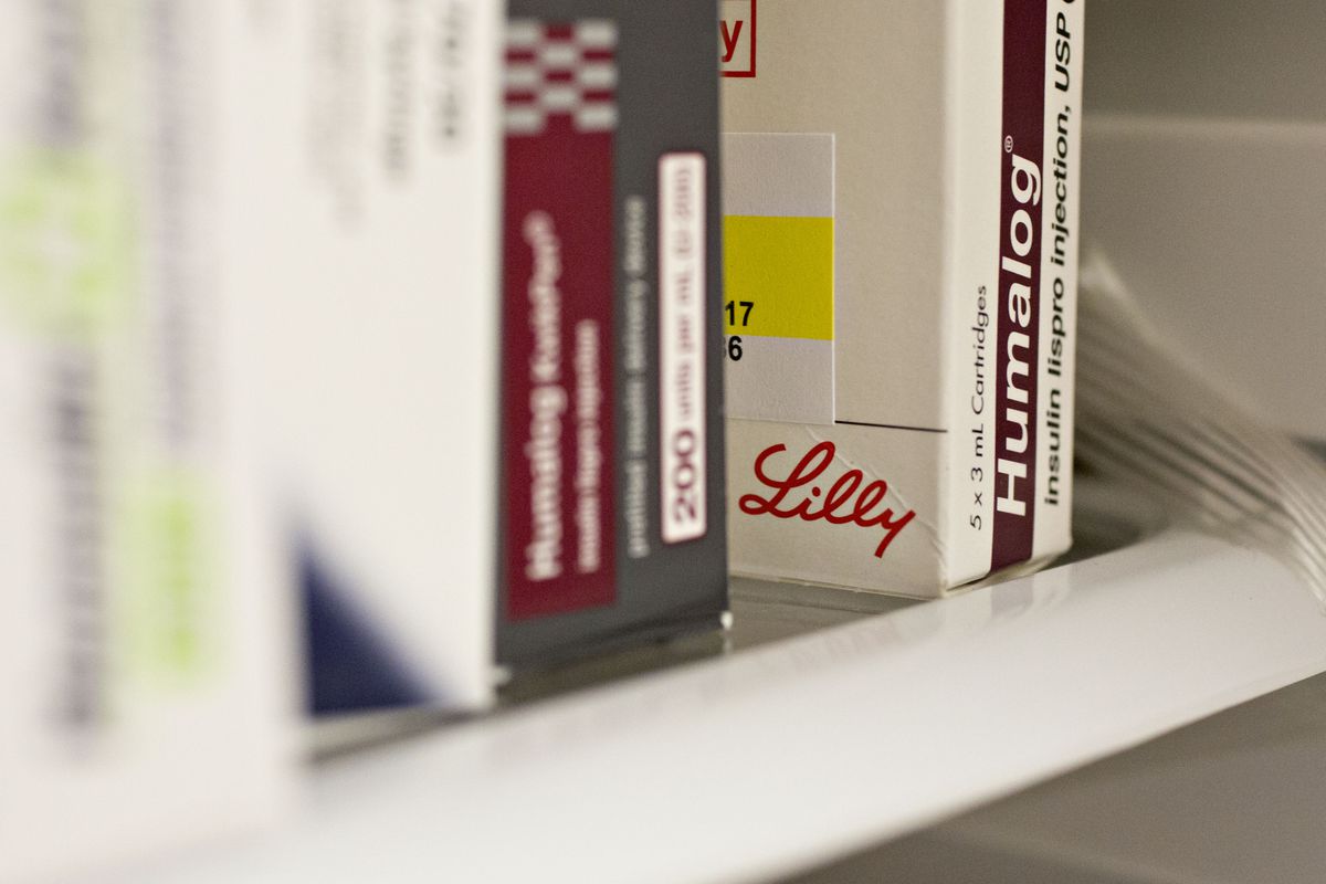 A box of Eli Lilly’s insulin medication Humalog sits on a pharmacy shelf. 
