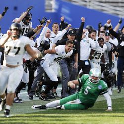 North Texas quarterback Alec Morris (5) looks on as Army celebrates their 38-31 win in overtime in the Heart of Dallas Bowl NCAA college football game Tuesday, Dec. 27, 2016 in Dallas. 