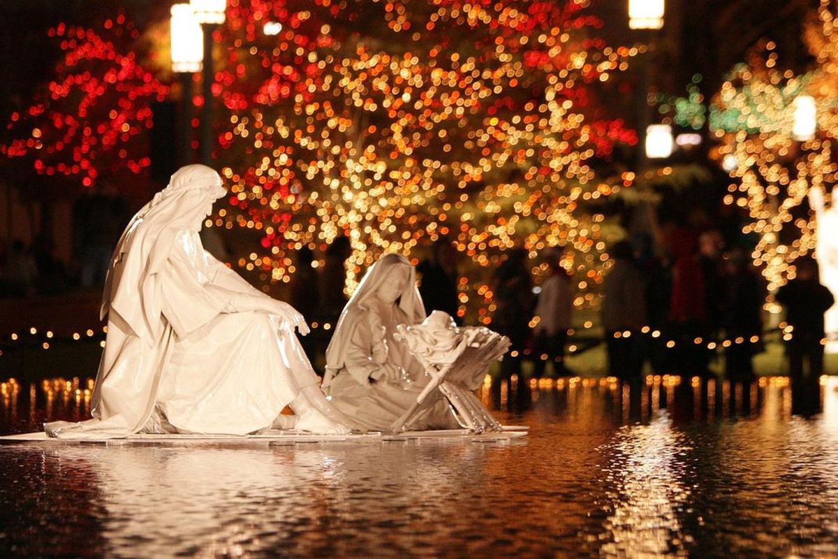 A nativity sits in the middle of reflecting pool as downtown visitors walk through the Church Plaza when Christmas lights were turned on downtown and at Temple Square in Salt Lake City on Friday, Nov. 25, 2014.