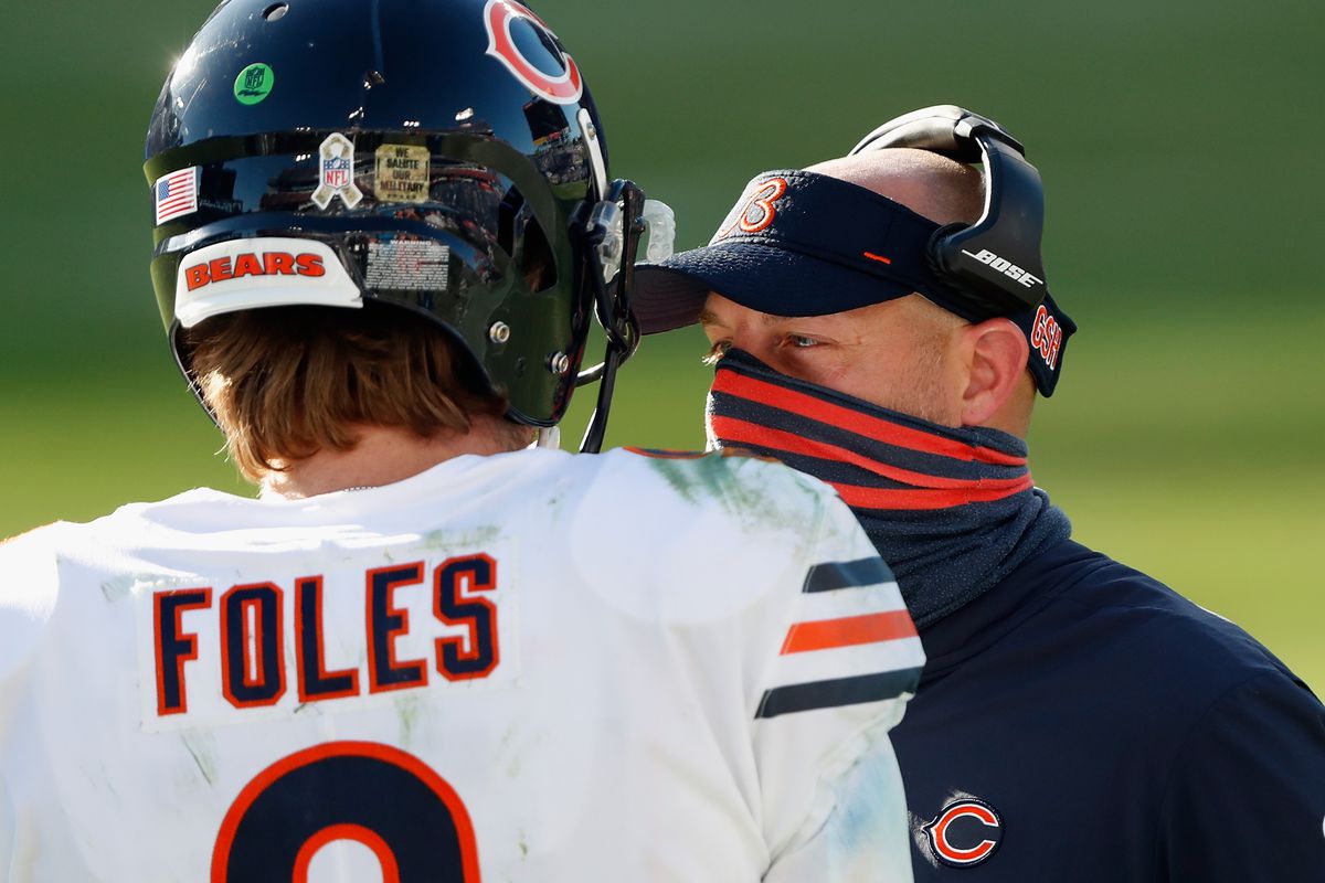 Bears coach Matt Nagy talks to quarterback Nick Foles on Sunday.