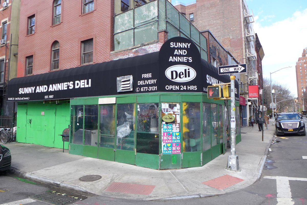 A Korean corner deli with a black awning.