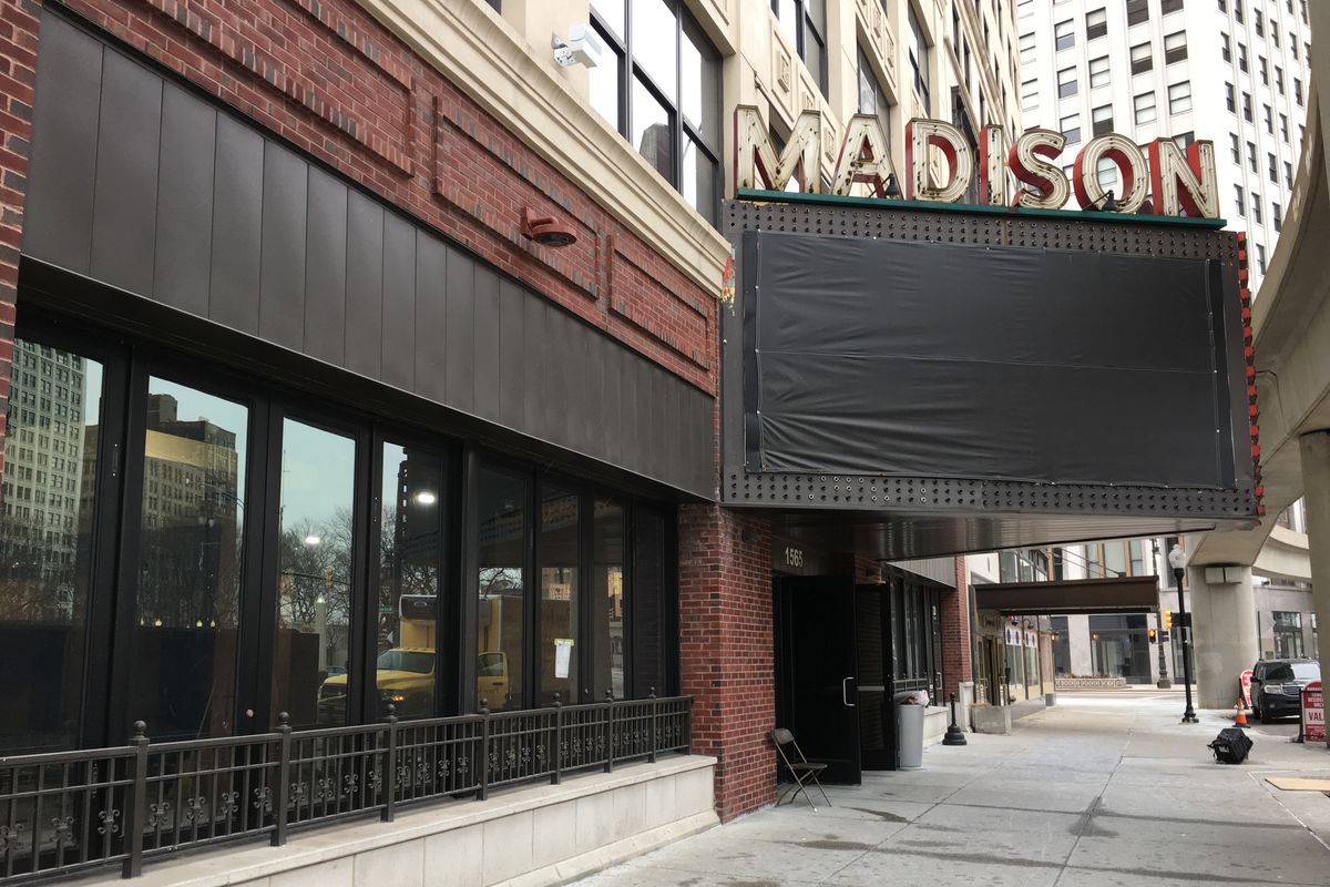 A photo of the Madison Building sign and Buddy’s restaurant front with blacked out windows.