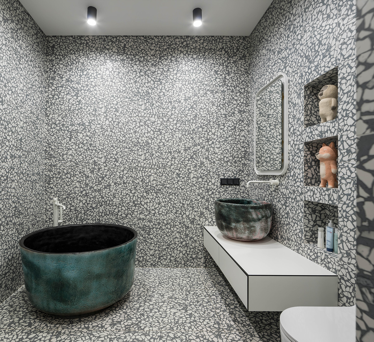 A bathroom with marbled walls and floors and a round bathtub.