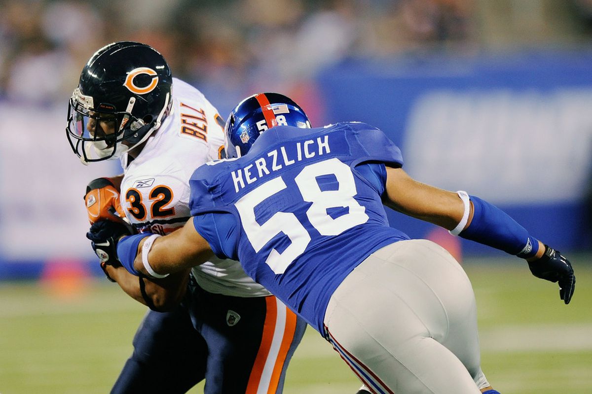 Mark Herzlich (58) of the New York Giants tackles Kahlil Bell (32) of the of the Chicago Bears during a pre season game at New Meadowlands Stadium on August 22, 2011 in East Rutherford, New Jersey.  (Photo by Patrick McDermott/Getty Images)