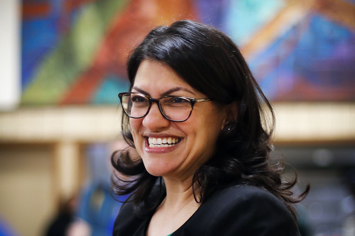 Rashida Tlaib smiles during a rally in Dearborn, Mich. 