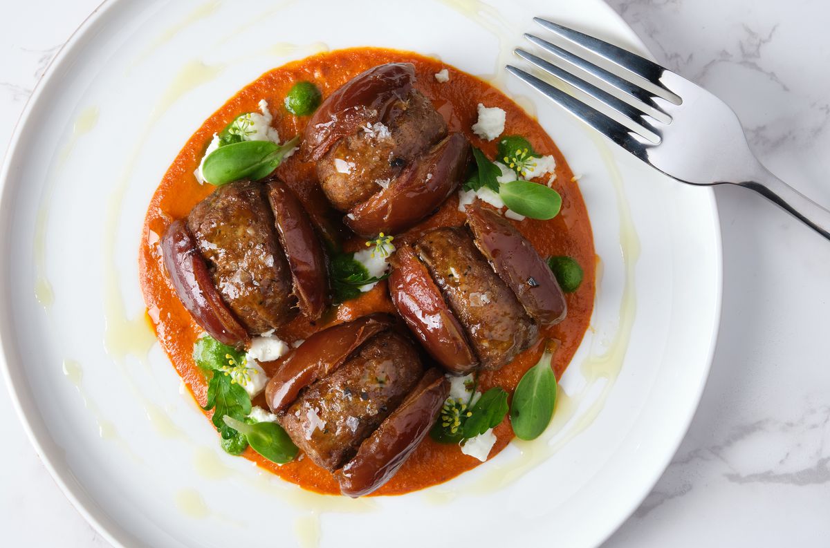 A plate of dates stuffed with lamb sausage.