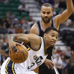 Utah Jazz's point guard Trey Burke (3) works to get past Spurs' Tony Parker as the Utah Jazz and the San Antonio Spurs play Saturday, Dec. 14, 2013 at EnergySolutions Arena in Salt Lake City. The Spurs won 100-84.